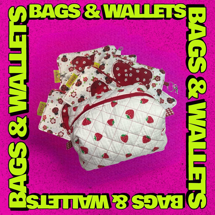 This image shows a pile of wallets and a make-up bag representing the category BAGS & WALLETS.